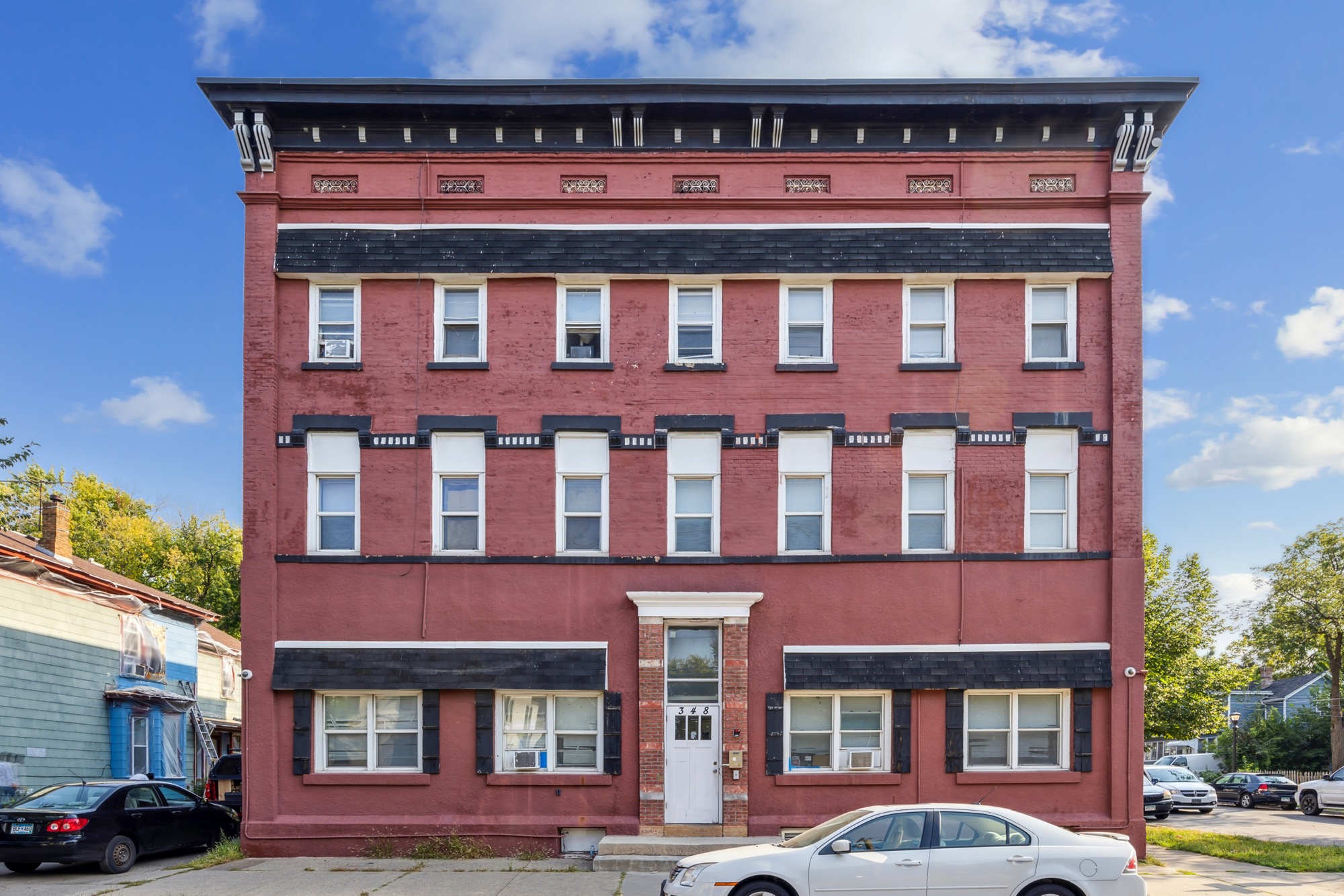 A restored red-brick apartment building sourced by Revolution Realty Group