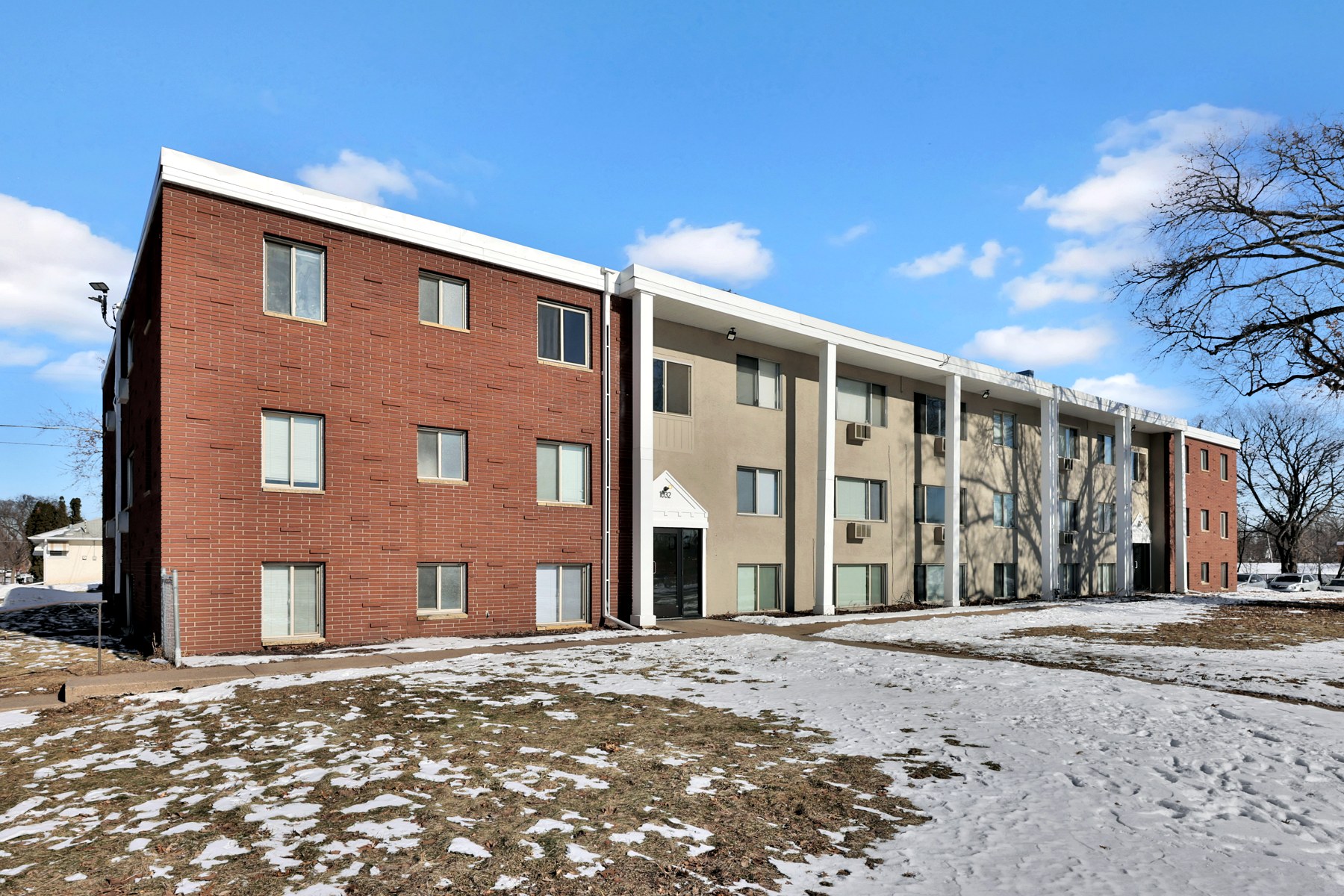 A classic arched-entry multifamily building underwritten by Revolution Investments