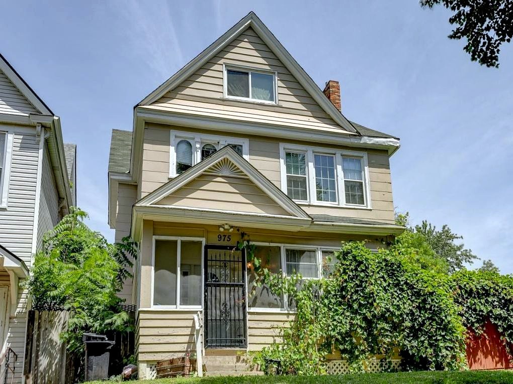 A classic Twin Cities multifamily home framed by mature trees